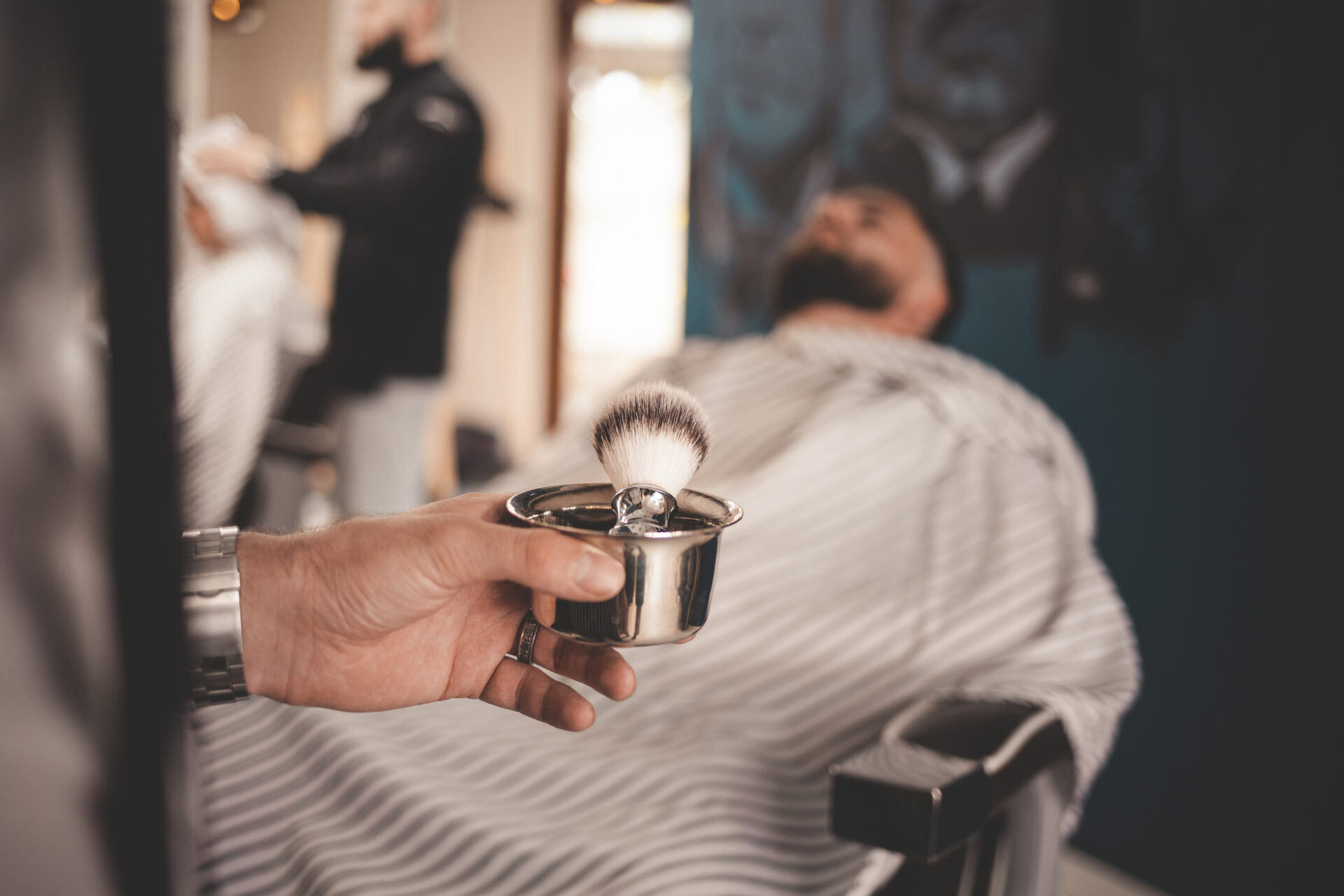 barber-holding-his-hand-brush-shaving Barber holding his hand brush shaving