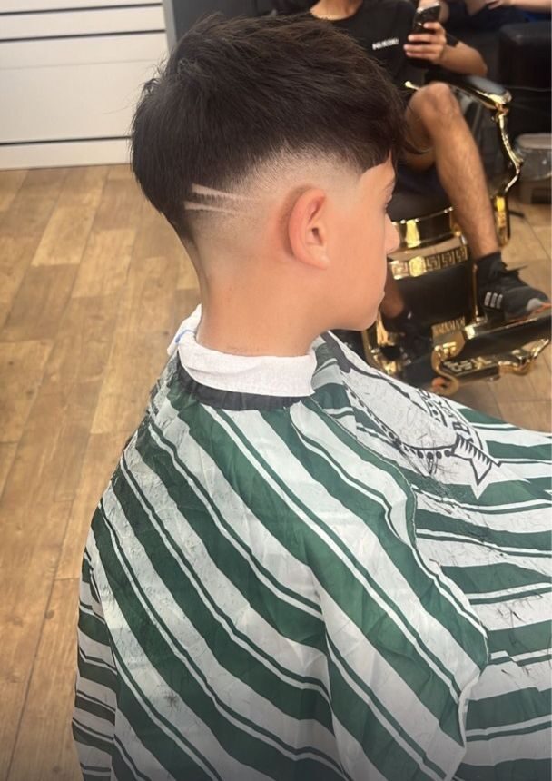 Corte de pelo con degradado y dibujo a un lado de la nuca realizado en Imperial barbershop