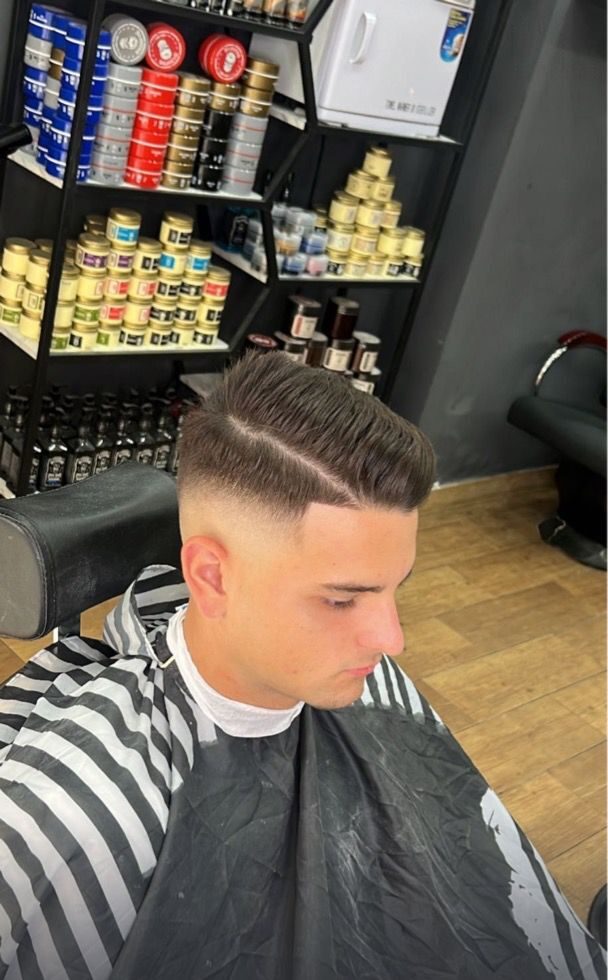 Corte de pelo con degradado y raya al lado realizado en Imperial barbershop